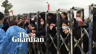 Footage shows people clamouring to get face masks at factory in Jiujiang
