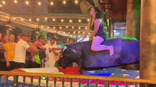 Brunette Girl In Black Dress Riding On A Mechanical Bull In Benidorm 4K