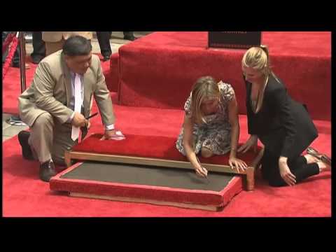 Jennifer Aniston has her foot and hand prints immortalised in cement outside