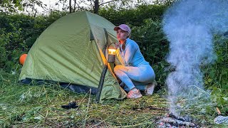 Young girl solo overnight camping - relaxing in the tent with the sound of natur