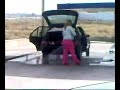 Dumb woman washing her car ... inside