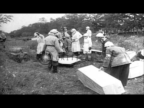 Dead bodies of soldiers killed by Nazis are exhumed from a mass grave and placed ...HD Stock Footage