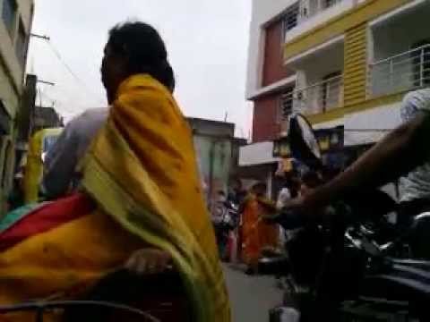 A INDIAN GIRL IN TRAFFIC WITH HER CYCLE