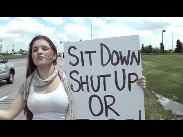 IRS Protest - Young Taxpayer with Sign - Sit Down, Shut Up or Else. ~ IRS