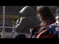A student girl is eating fastfood salad with a roll while waiting for a bus Free HD video footage