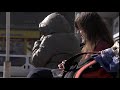 A student girl is eating fastfood salad with a roll while waiting for a bus Free HD video footage