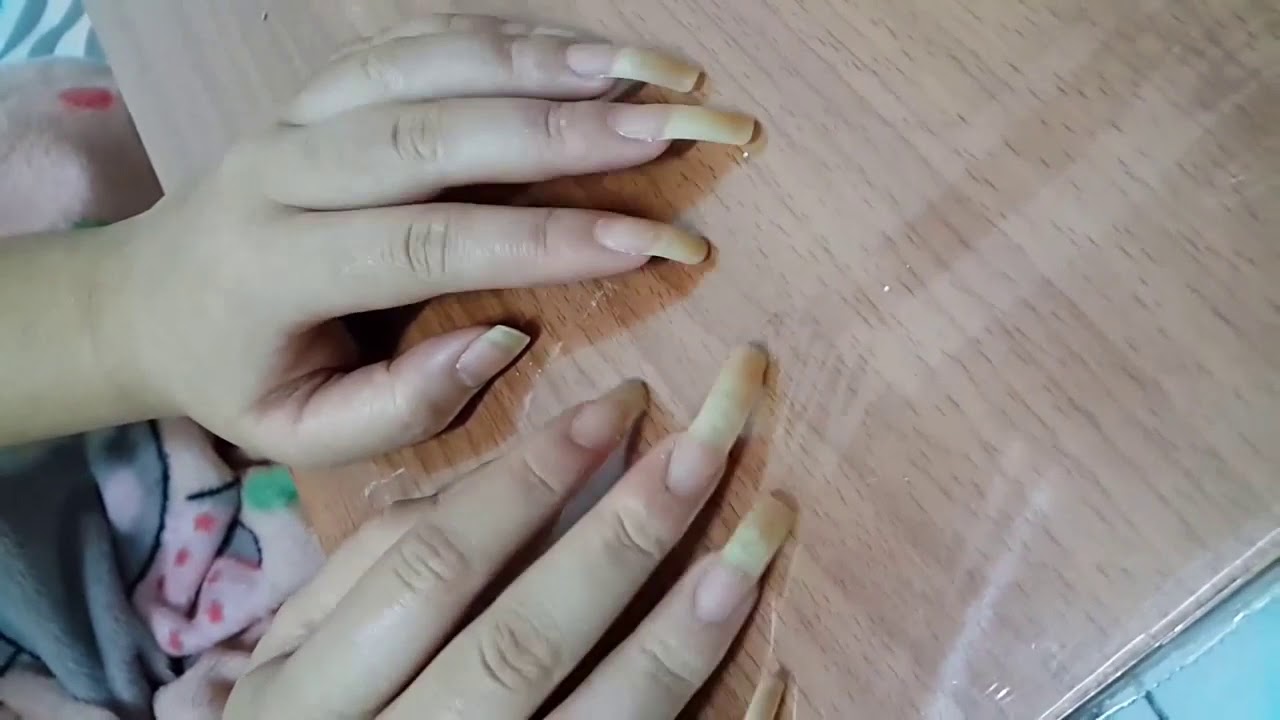 Long unpolished fingernails giving hand