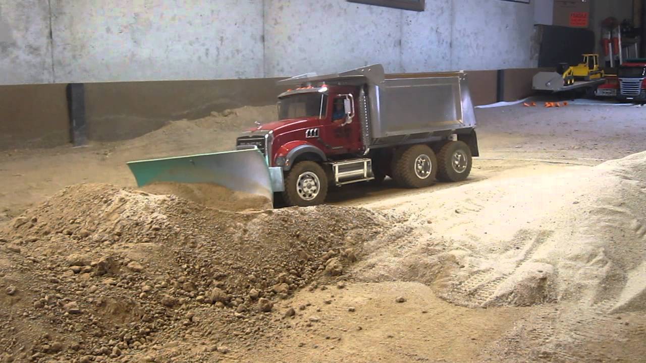 My Mack dump truck pushing dirt with a snow plow blade ...