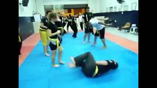 Girl Drops Guy With A Surprise Kick In The Balls From Behind In A Dojo