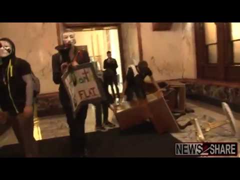 Anonymous At Donald Trump's DC Hotel With "The Earth Is Flat" Sign