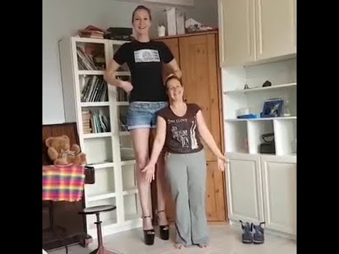 Tall girl compares heights with fan pic