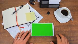 Businessman Using A Modern Smartphone /  Tablet Pc With Green Screen At His Desk - Free Use