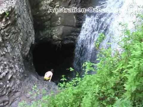 gold coast queensland australia caves. Jumping down a waterfall into a cave - fun at Australia#39;s rainforest.