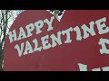 Woman celebrates with big wooden heart