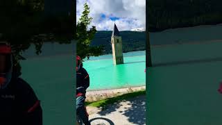 Riding Around The Old, Submerged Belltower Of Grauncuron In Italy.