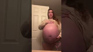 A Pregnant Woman Happily Rubbing Her Hand On Her Big Belly Just To Say Hello To Her Baby