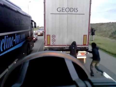 Illegal immigrants in french port of calais try to jump on Lorries headed for UK