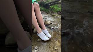 Women Showing Feet With White Socks In The River