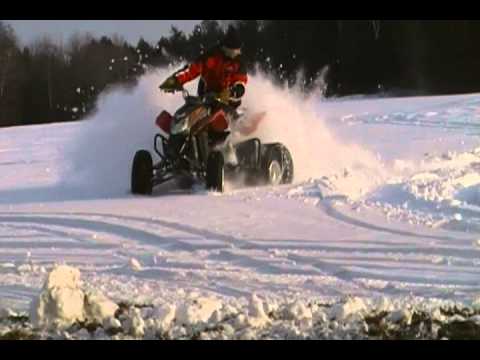 racing fourwheeler with snowmobile tracks