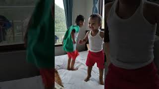Two Little Kids Jumping On The Bed