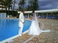 Newly weds jump in the pool in their wedding outfits