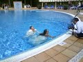 Newly weds jump in the pool in their wedding outfits