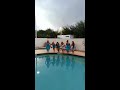 Bride and bridesmaids jump into pool