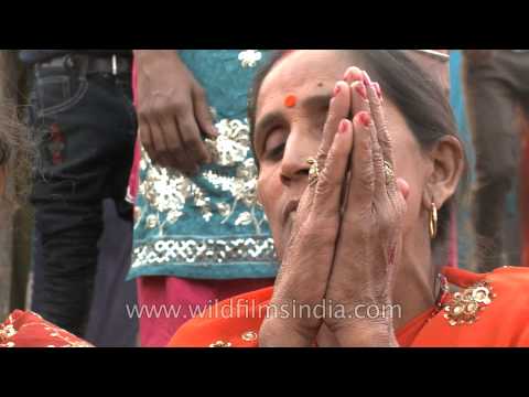 Hindu devotees offer prayers to the Sun God at sunset