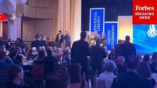 Shock Moment Protesters Rush Stage As Charles Koch Accepts Award From The Cato Insute In D.c.