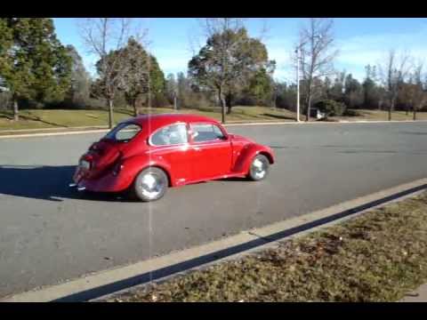 A 1974 VW Beetle and Karmann Ghia make passes The Beetle is electric and