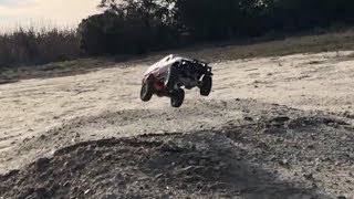 WPL C24 tests suspension upgrade by going off jump and drifting in dirt