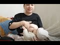 Mother breastfeeds and plays with baby before going to bed