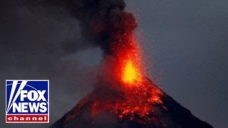 Erupting volcano lights up night sky in Philippines