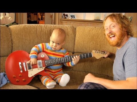 A Child Playing the Guitar