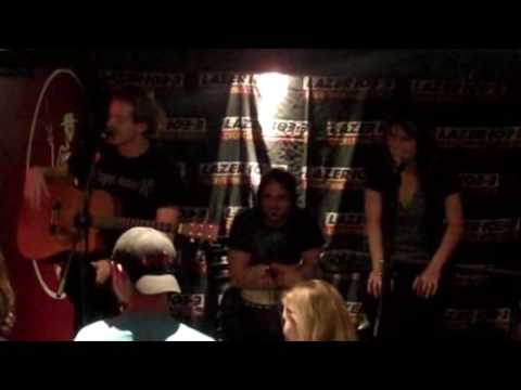Lazer 103.3's Andy Hall interviews the Sick Puppies between songs at a Lazer 103.3's Andy Hall interviews the Sick Puppies between songs at a