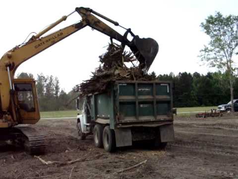 Caterpillar track hoe taking 2011 caterpillar truck. Caterpillar track hoe taking