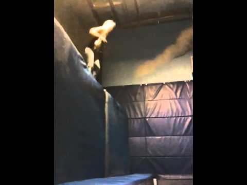 Girl front flips into the foam pit at the fantasy factory.