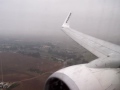 Ryanair 737-800 landing at a rainy Seville airport