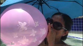 Pink Erfly Balloon Blowing A Balloon In The Pool