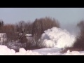 Train plows through snow bank