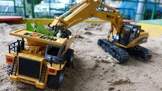 Kids' excavator & toy truck for kids in the sandpit.