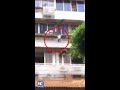 Boy hanging on window railings rescued by passers-by