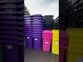 Stacks of red and purple wheelie bins #recycling