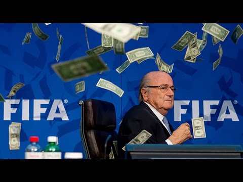 Sepp Blatter showered with banknotes as prankster Lee Nelson storms Fifa press conference