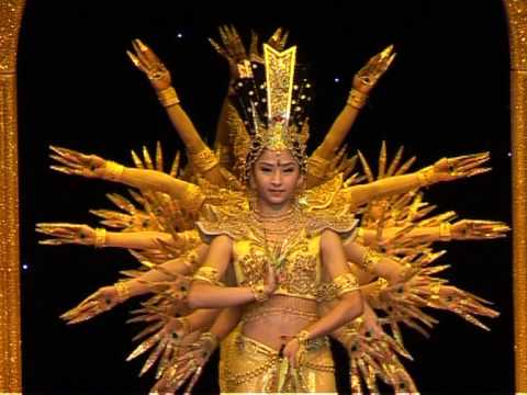 Video image of  Chinese Deaf dancer with hands encircling her from the back.