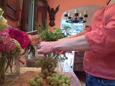 a tall wedding centerpiece with green grapes dendrobium orchids