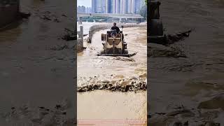 Loader Cleans Up Silt After River Overflows