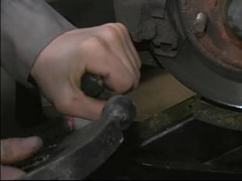 Learn how to remove the brake calipers on a car in order to adjust the wheel 