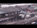 Hundreds of freezing refugees and migrants wait for food in Belgrade - drone video