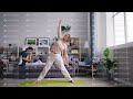 Female student doing yoga while husband working with laptop talking on phone